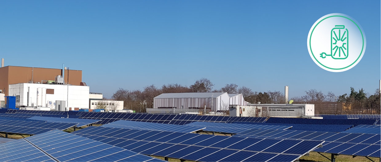 Blick über den Solaspeicherpark mit seinen Solarpanels. Im Hintergrund befinden sich die Bioliqanlage und das SEnSSiCC-Gebäude